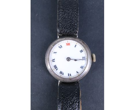 A 1913 silver wristlet watch, having an un-named Swiss movement and enamel face with "red XII" and blued steel poker hands, L