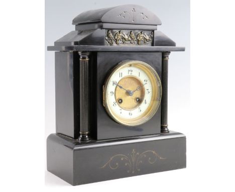An early 20th Century black slate mantle clock, having a drum movement with a pendulum escapement striking on a gong, 24 x 12