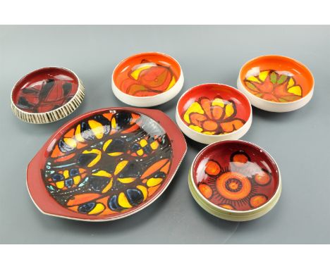 A large Poole Pottery dish together with five Delphis pattern bowls, latter shape number 88, former 34.5 cm