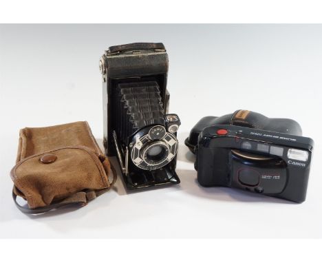 A 1930s Art Deco influenced Kodak Six-20 folding rollfilm camera together with a Canon Sureshot Supreme