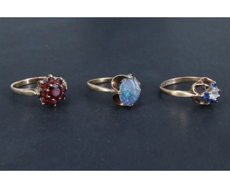 Three 9 ct gold rings, variously set with opal, almandine, quartz and pastes, Sheffield, 1977 and 1974, London, 1971, 6.04 g 
