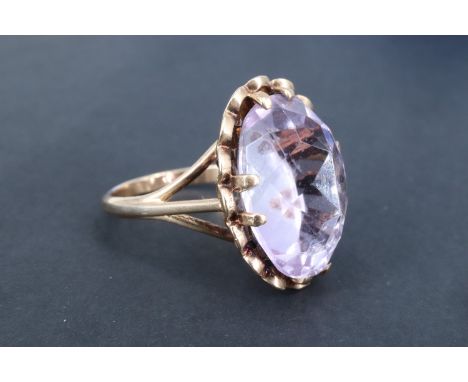 An unusual vintage amethyst dress ring, having an inverted 14 x 18 mm oval cut stone displaying the pavilion uppermost, claw 