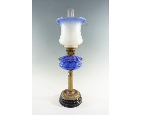 A Victorian columnar brass and blue glass oil lamp, having a two tone blue font, a duplex coronet burner and an achromatising