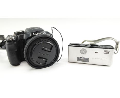 A Minolta 16 Model P camera together with a Lumix Panasonic DMC-FZ62 digital camera