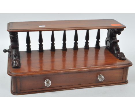 A 19th century Victorian mahogany wall shelf with drawer. Single drawer with spindle gallery back having raised shelf. Mounts