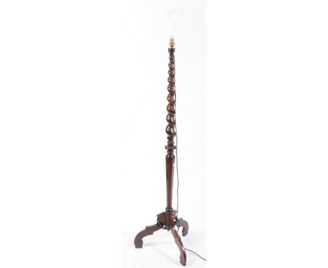 A 19th century Victorian mahogany  wood barley twist floor standard lamp. The lamp raised on a tripod base, with shaped legs.