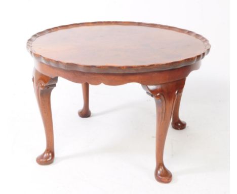 A 1930s Art Deco 20th century burr walnut pie crust top occasional table. The circular top with carved cabriole legs raised o