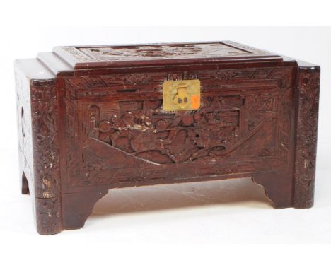 A 20th century Chinese camphorwood blanket box chest. Featuring a campherwood body carved in relief depicting horse riders am