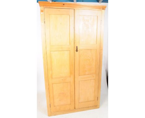 A Victorian 19th century pine vestry church two door wardrobe. Pediment top with twin full size fielded panel doors with a sh