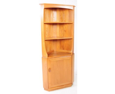 Ercol Furniture - A retro 20th century Ercol beech and elm corner cabinet unit. The cabinet raised on a plinth base with cupb