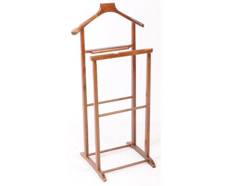 A 1930s Art Deco walnut gentleman valet clothes stand. Having the hanger form top, trousers fold bar stand united by stretche