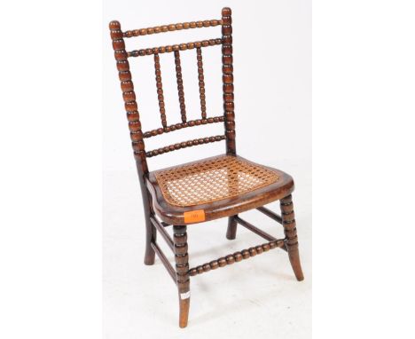 A Victorian 19th century William &amp; Mary revival bobbin turned children's chair. Having a rattan seat with bobbin turned b