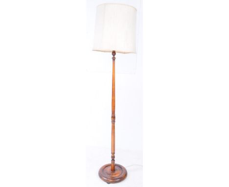 A mid 20th century circa 1940s mahogany inlaid standing standard floor lamp. Circular base with turned central column with li