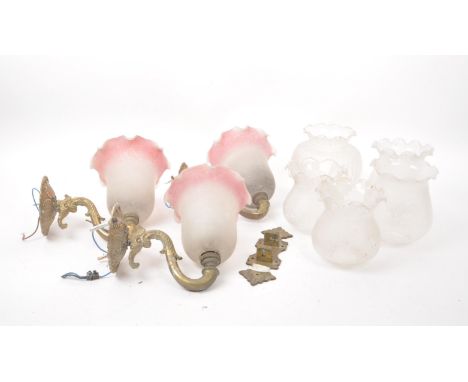 A set of five Victorian / Edwardian oil lamp covers with waved rim and floral design pattern. Four measuring 14cm in height, 