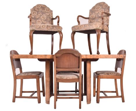 An Art Deco early 20th century circa 1930s figured walnut veneered extending dining table and six chairs. The table having a 