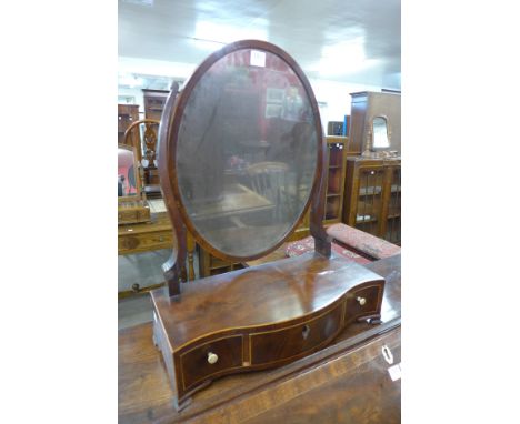 A George III mahogany serpentine toilet mirror