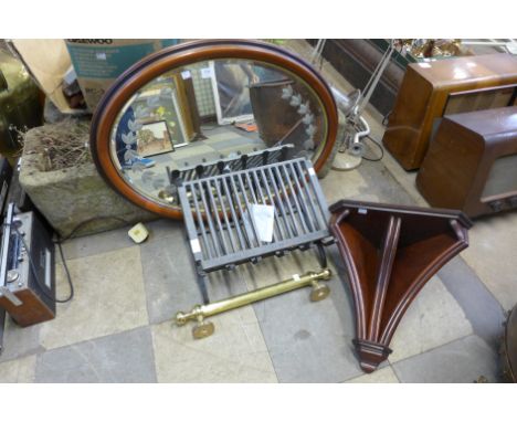 An oval mirror, fire grate, brass hand rail and a mahogany corner shelf