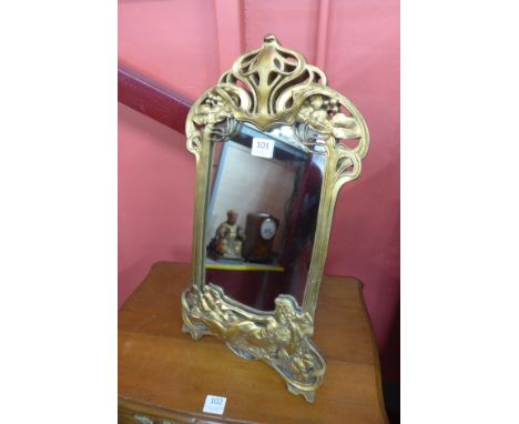 An Art Nouveau style gilt framed toilet mirror