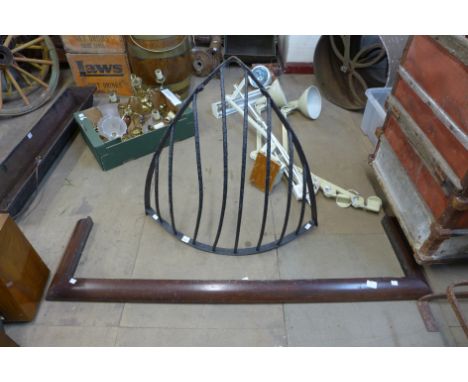 A cast iron hay rack and a mahogany fender