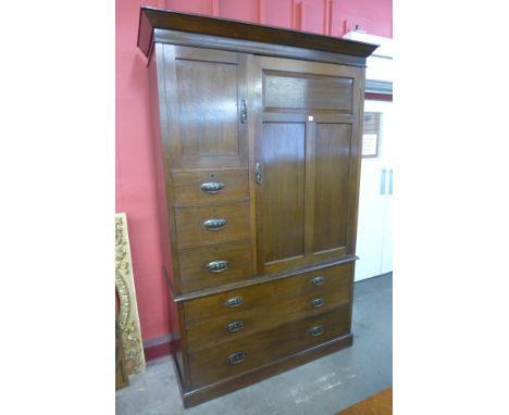 An Arts and Crafts oak wardrobe by Simpson & Sons, Halifax