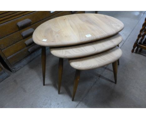 An Ercol pebble shaped nest of tables