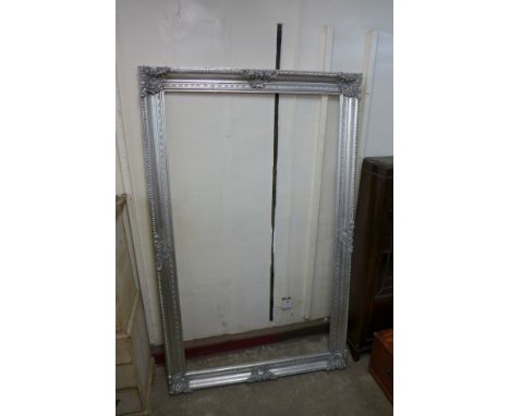A large silver effect mirror frame