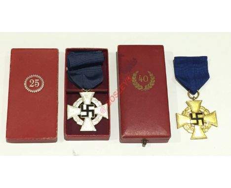 German Third Reich 2 cased Faithful Service Decoration. A fine 1st class gilt example with black enamel swastika on cornflowe