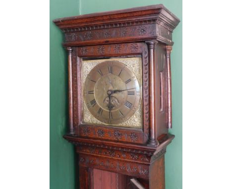 Wainwright, Northampton. An 18thC oak longcase clock, with floral and crescent moon carved hood, sunflower trunk door, and sc