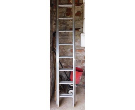 An extending ladder, garden spreader, scythe and axle stands.