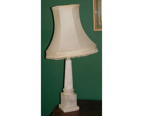 A white alabaster columnal table lamp with shade.