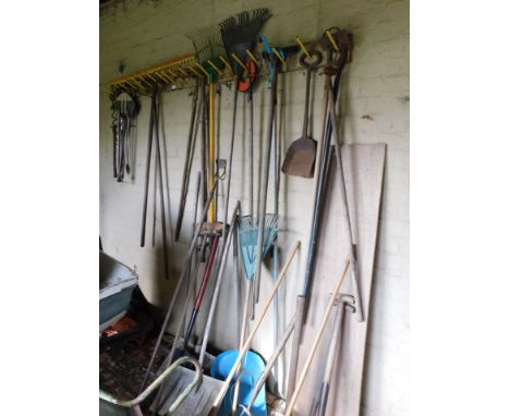 Various garden tools including rakes, snow shovels, spades, Flymo garden vac, etc. (all on rear wall and side wall of Arch no