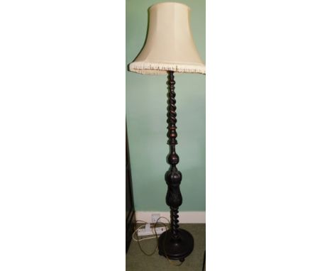 An early 20thC open barley twist carved standard lamp and shade.