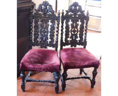 A pair of 19thC carved oak dining or hall chairs, with barley twist uprights and central Celtic cross.