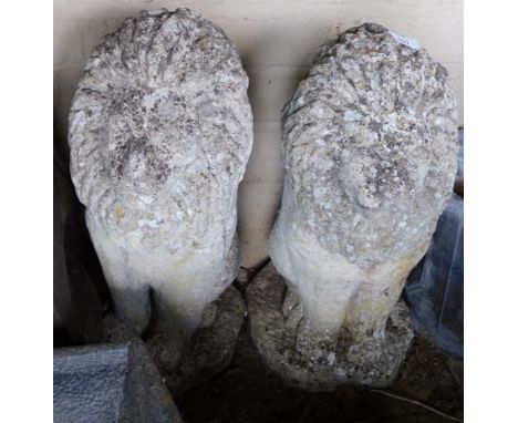 A pair of reconstituted stone lion gate post finials, 52cm high.