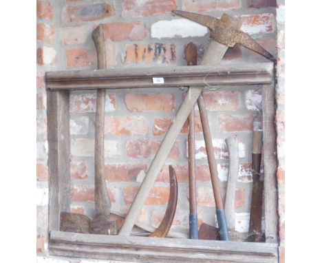 Various tools and implements, contained in the racking of Arch No. 2, including axes, scythes, hanes, ropes, chains, etc.