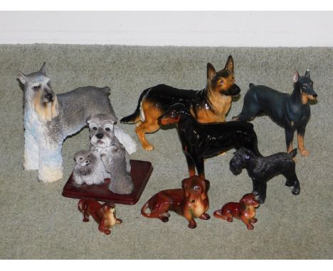 A Goebel pottery model of a German Shepherd dog, a Beswick model of a Doberman Pincher and seven other dog ornaments.  (9)