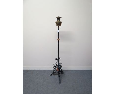 A Victorian brass and iron standard lamp of Arts and Crafts design 
