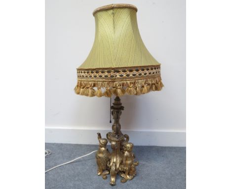 An ormolu lamp base in the French taste with figural putti detail, tasselled shade, 65cm tall