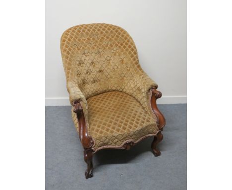 A Victorian button back armchair with scroll arms, cabriole legs to castors