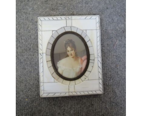 A 19th Century Continental School miniature portrait of female wearing a lace slip, signed Fabry in bone frame, 8cm tall