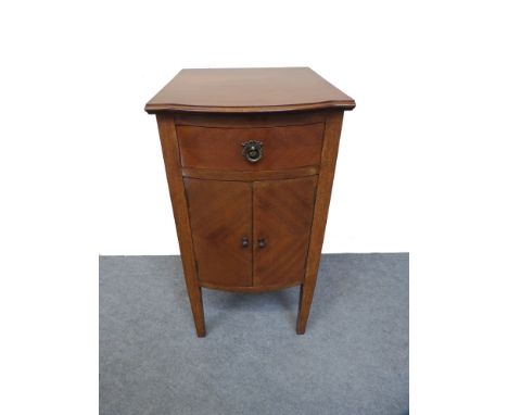 An Edwardian mahogany bow front cabinet, the single drawer over a two door cupboard on square tapering legs 