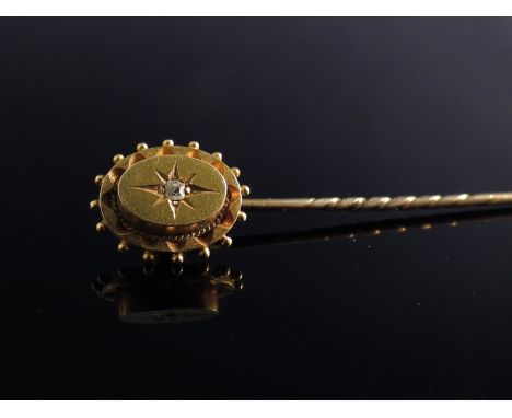 A 15ct gold stick pin set with single diamond 