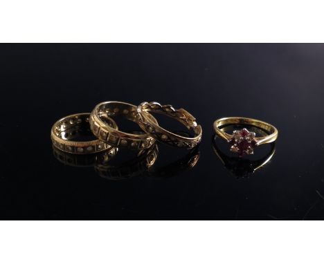 An 18ct gold ruby and diamond floral ring and three 9ct gold eternity rings, approximately 8g (4)