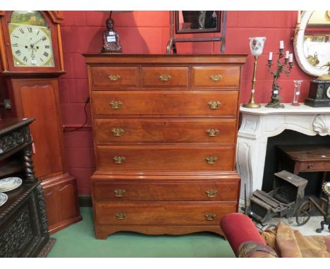 A George III style walnut chest on chest, the three short over five long drawers with brass swan neck handles over bracket fe