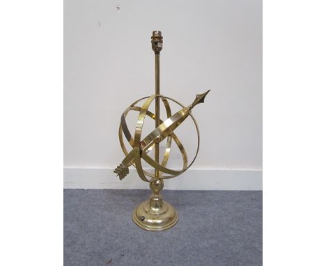 A brass armorial sphere desk lamp 