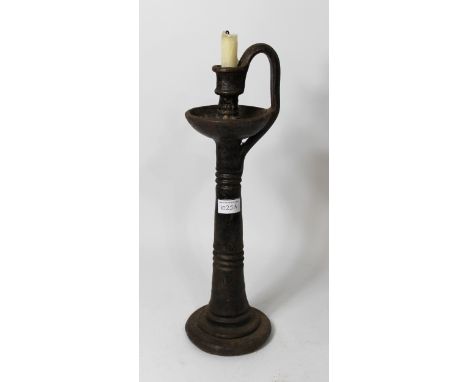 19th Century heavy cast iron blacksmith's candle stand, a large wrought iron poker and another smaller