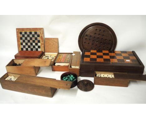 19th Century inlaid chess and backgammon board with folding action, together with a quantity of boxed chess pieces, dominoes,