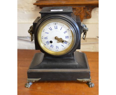 19th Century French black slate and brass mounted mantel clock with lion mask side handles, the enamel dial with Roman and Ar