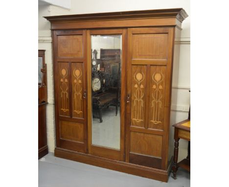 Art Nouveau mahogany and inlaid bedroom suite comprising:  three door wardrobe, dressing table, dressing chest, double bedste