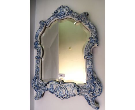 Late 19th / early 20th Century Delftware dressing table mirror, the arched top above a bevelled plate, the frame decorated wi